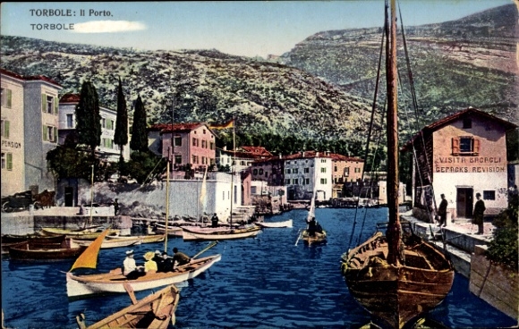 Postcard Torbole Lago di Garda Trentino, view of the harbor, boats in the water, buildings on the shore, mountain cul