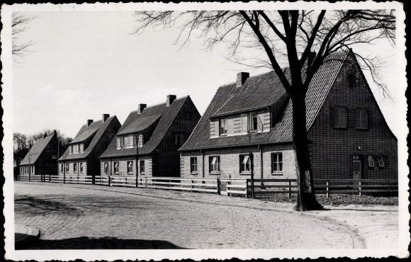 foto Ak Tönning op de Eider Nordfriesland, straatgedeelte met woongebouwen