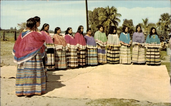 Postcard Boca Grande Florida USA, A group of Seminole women in traditional clothing stands in front...