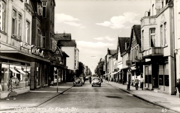 PC Nordenham in Oldenburg, Lower Saxony, Fr. Ebert Street, shops, cars, black and white photo...
