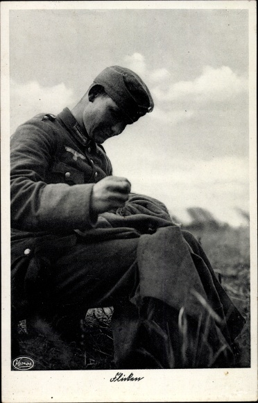 Postcard Wehrmacht soldier patching