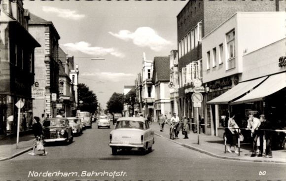 Postcard Nordenham in Oldenburg, Lower Saxony, Bahnhofstraße, city view, cars, former shops