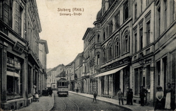 Postcard Stolberg in the Rhineland, Steinweg Street, A. Schulte store, tram