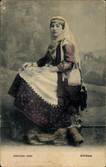 PC Athens Greece, Greek woman in traditional costume, sitting on a rock
