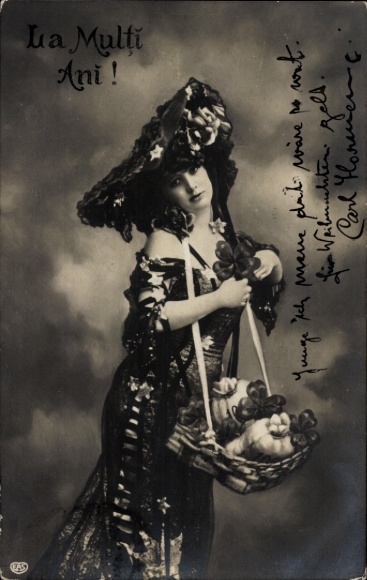 Postcard Happy birthday, woman with clover leaves and money bags in a basket