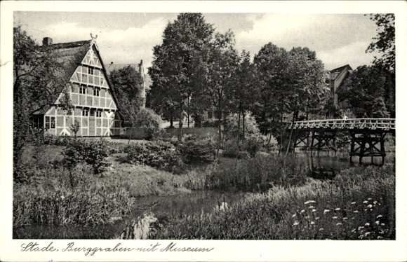 Postcard Stade in Lower Saxony, historic half-timbered house, moat, museum, bridge, trees
