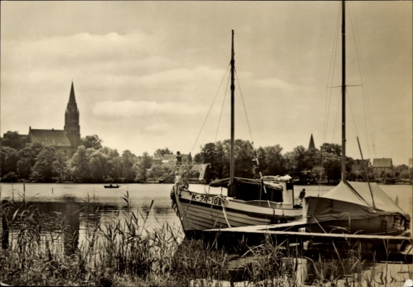 Postcard Röbel on the Müritz, boat on the water, church in the background, quiet natural landscape, architect