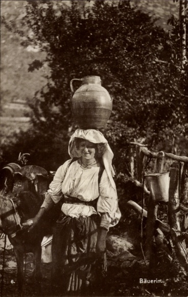Postcard Greek peasant woman from the island of Corfu, carrying a jug on her head