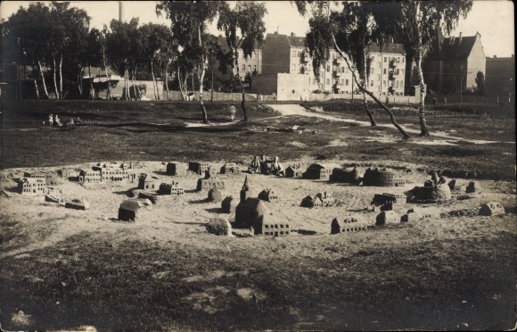 Photo Postcard Castles built from sand, in the background, houses