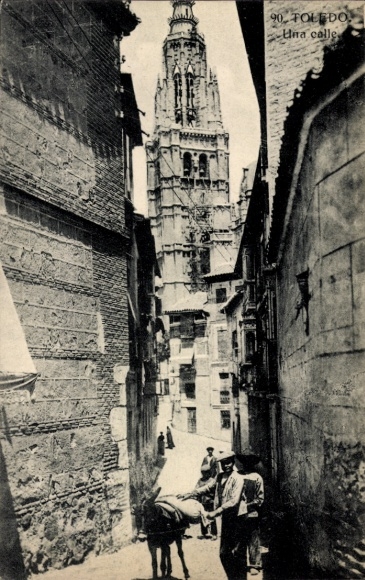 Ak Toledo Kastilien La Mancha Spanien, Stadtansicht, Straße mit Gebäude, Turm, Menschen, Esel