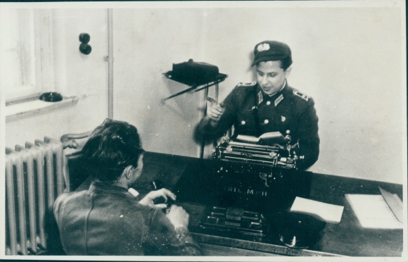 Photo Man in uniform at a desk, Triumph typewriter, GDR, People&#39;s Police