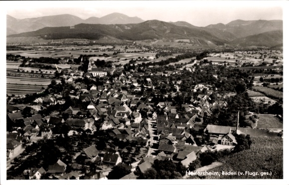 Postcard Heitersheim in the Black Forest, aerial view of many roofs, landscape, mountains in the background