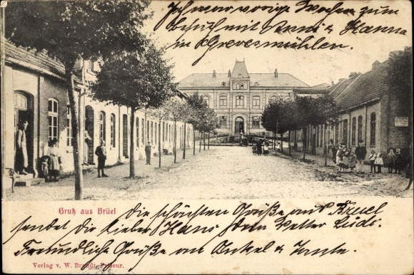 Postcard Brüel in Mecklenburg, street section, official building, passers-by