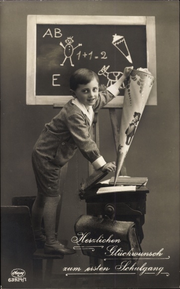 Postcard Congratulations on school enrolment, boy with satchel and bag of sugar, writing desk, blackboard