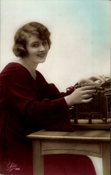 Postcard Young woman at the table, typewriter