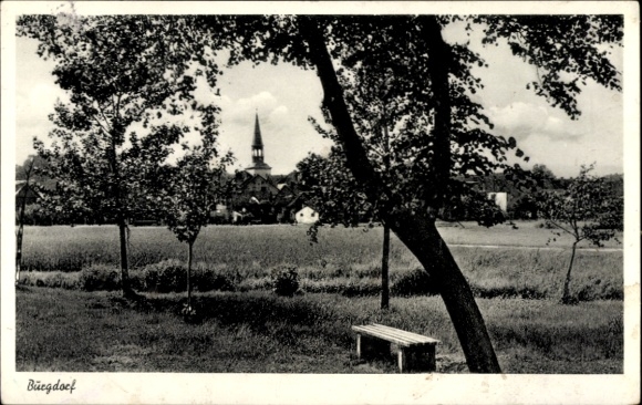 Burgdorf PC in the Hanover region, beautiful landscape, church visible, trees, bench in the...