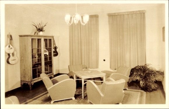 Postcard Oberhof in the Thuringian Forest, cozy club room, retro-style furniture, curtains, plants