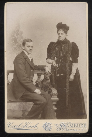 Cabinet photo woman with hat, young man, dachshund