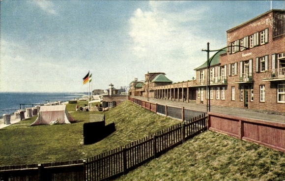 Postcard Wilhelmshaven on the North Sea, view of beach promenade, buildings, German flag, sunny background