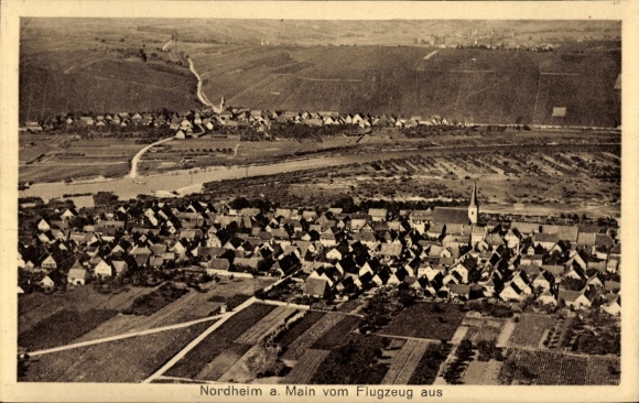 Postcard Nordheim am Main Lower Franconia, aerial view of Nordheim, houses, church, fields, mountains