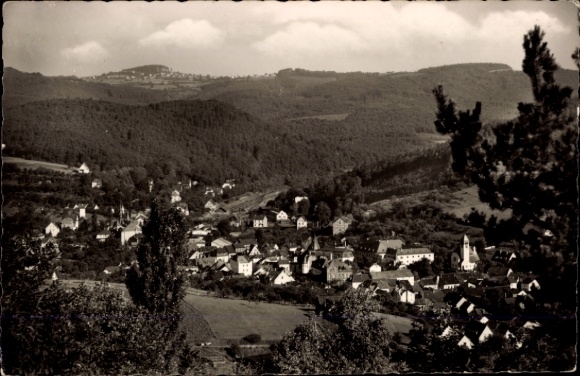 Postcard Adenau in the Eifel, landscape with many houses, forest in the background, church visible