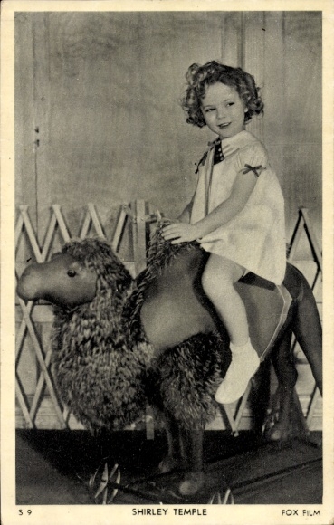 Postcard actress Shirley Temple sitting on a plush camel
