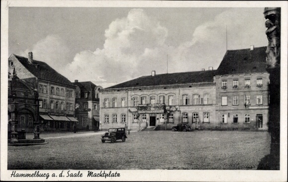 Postcard Hammelburg in Lower Franconia Bavaria, town square with buildings, car, clouds, partly people