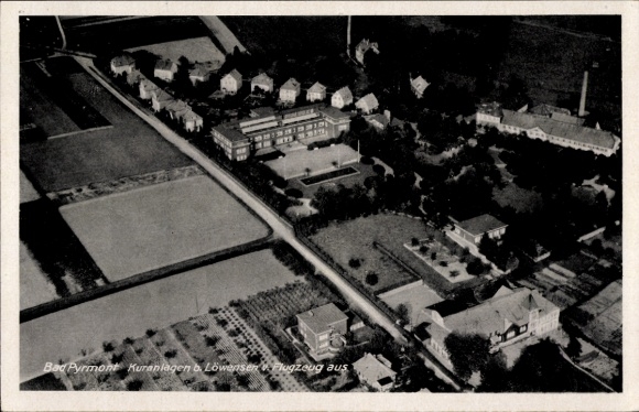 Postcard Bad Pyrmont in Lower Saxony, aerial view of spa facilities, buildings, farmland