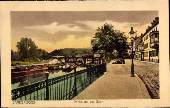 Postcard Saarbrücken in Saarland, river landscape on the Saar, bridge, trees, lantern, waterfront promenade