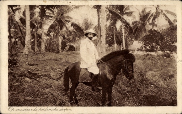 Postcard Indonesia, Dutch missionary on his way to pagan villages, pony
