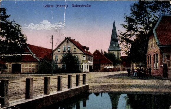 Postcard Lehrte in Lower Saxony, city view with houses, church in the background, waterfront