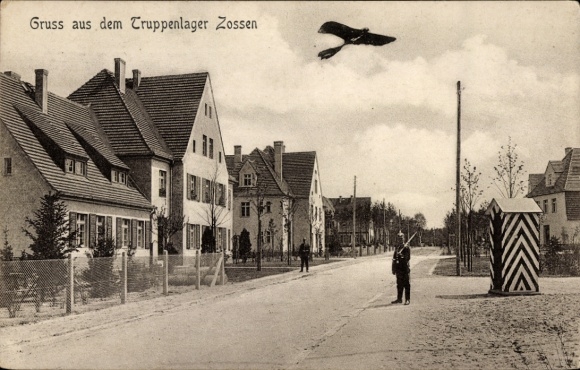 Postcard Zossen in Brandenburg, troop camp, street section, guard, aircraft