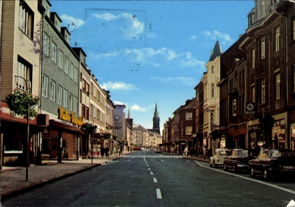 Postcard Viersen in North Rhine-Westphalia, view of streets with buildings, cars, and church tower in the background...