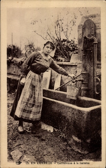 Postcard En Correze, woman in French costume, Corrézienne at the fountain