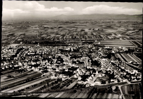 Postcard Plankstadt in the Kurpfalz, aerial view of many fields and houses, cloudy sky
